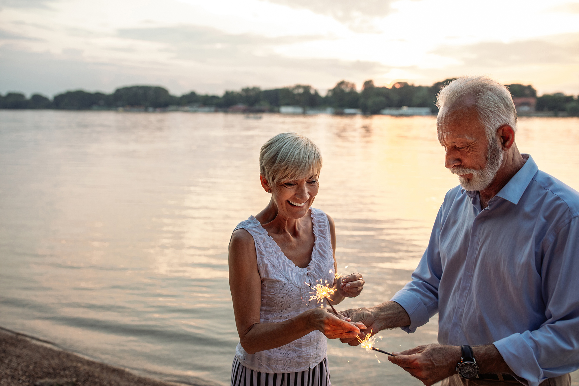 retired couple holding sparklers